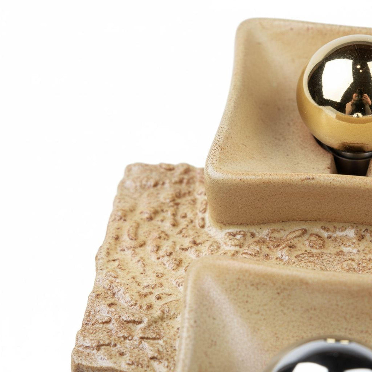 a close-up view of a ceramic object with a textured surface, possibly a dish or bowl.